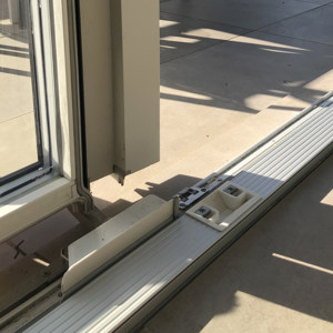 Adjustable striking plate under the french casement mullion